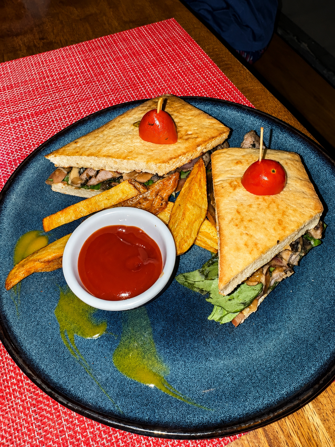 Toasted sandwich with fries and dipping sauce served on Picnic's signature blue plate.